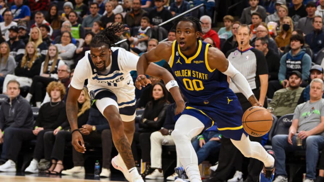 Nov 27, 2022; Minneapolis, Minnesota, USA; Golden State Warriors forward Jonathan Kuminga (00) drives to the basket as Minnesota Timberwolves center Naz Reid (11) during the second quarter at Target Center. Mandatory Credit: Nick Wosika-USA TODAY Sports