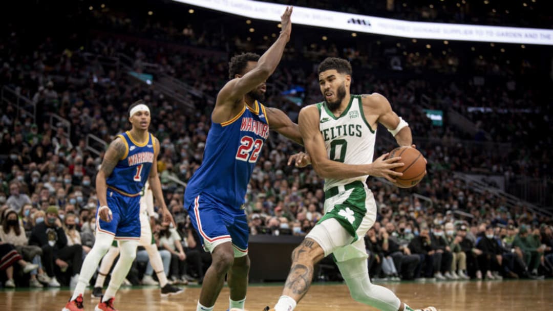 BOSTON, MASSACHUSETTS - DECEMBER 17: Jayson Tatum #0 of the Boston Celtics drives to the basket against Andrew Wiggins #22 of the Golden State Warriors at TD Garden on December 17, 2021 in Boston, Massachusetts. NOTE TO USER: User expressly acknowledges and agrees that, by downloading and or using this photograph, User is consenting to the terms and conditions of the Getty Images License Agreement. (Photo by Maddie Malhotra/Getty Images)