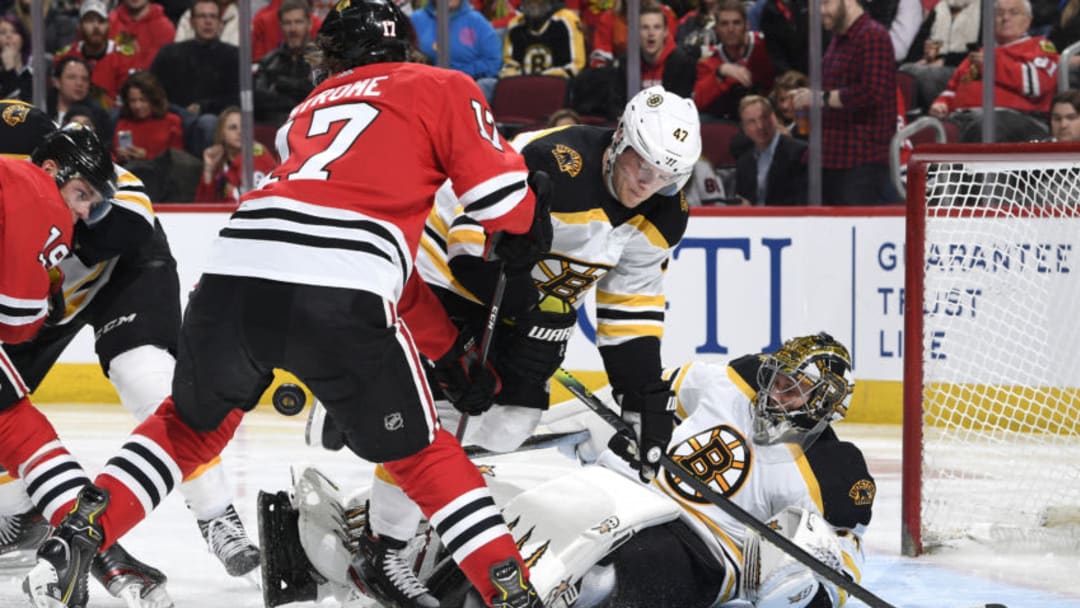 CHICAGO, IL - FEBRUARY 05: Dylan Strome #17 of the Chicago Blackhawks pushes into Torey Krug #47 of the Boston Bruins as goalie Jaroslav Halak #41 lays on the ice in the third period at the United Center on February 5, 2020 in Chicago, Illinois. (Photo by Bill Smith/NHLI via Getty Images)