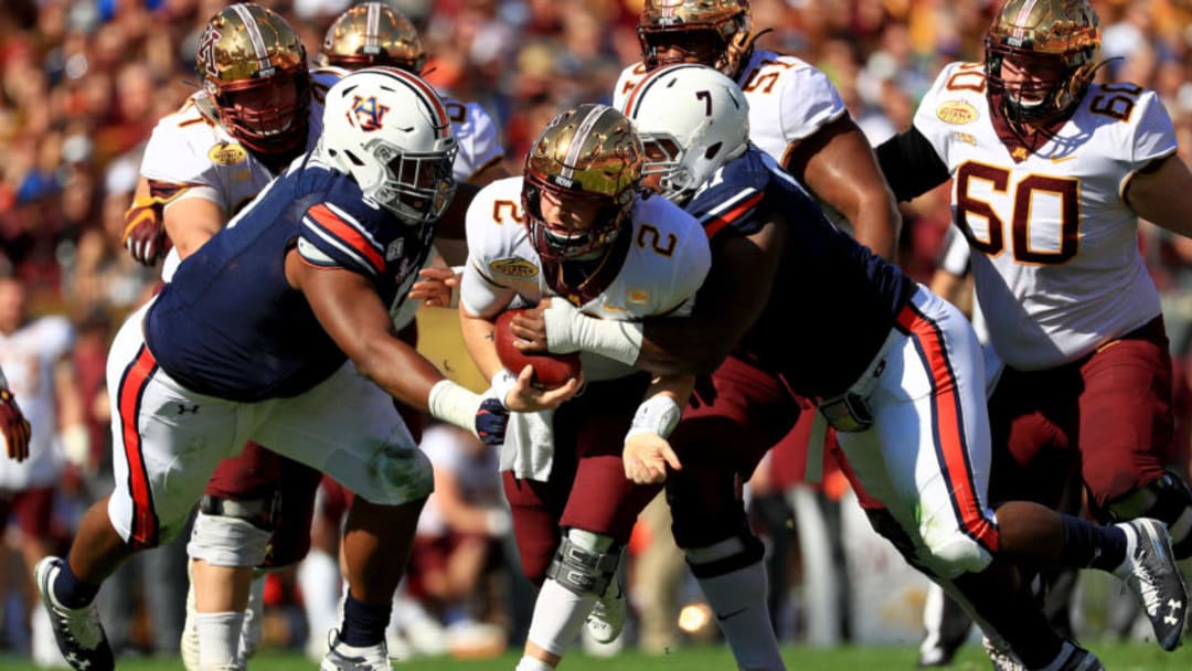 Tanner Morgan #2 of the Minnesota Golden Gophers is tackled by Nick Coe #91 of the Auburn Tigers (Photo by Mike Ehrmann/Getty Images)