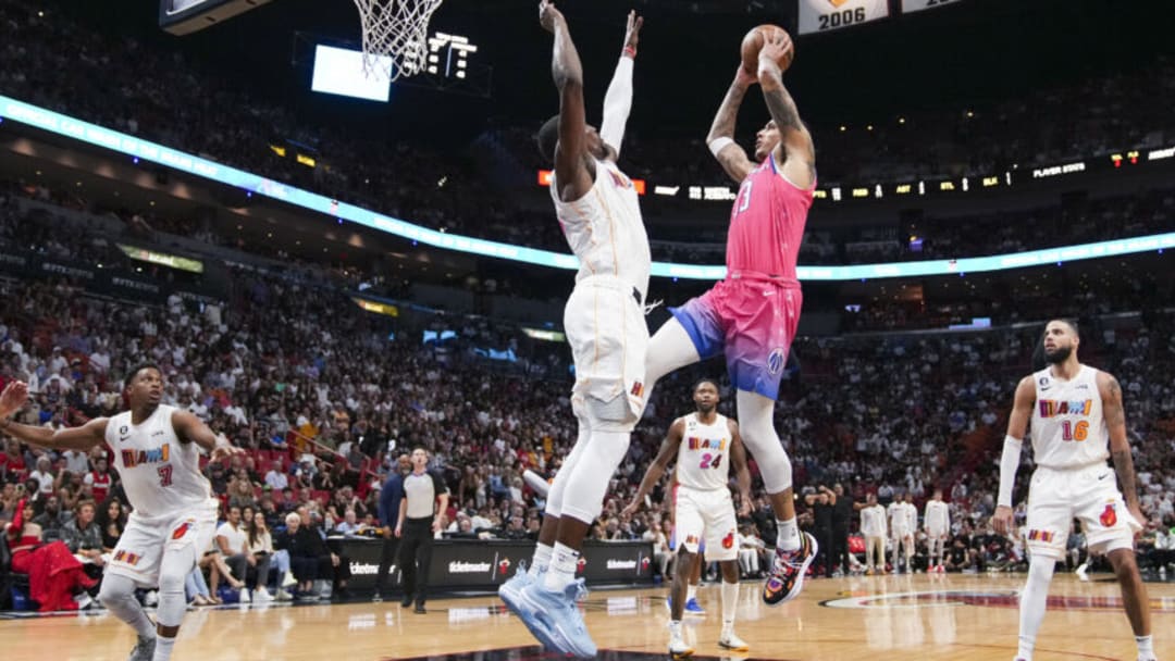 Kyle Kuzma #33 of the Washington Wizards drives to the basket while being defended by Bam Adebayo #13 of the Miami Heat (Photo by Eric Espada/Getty Images)