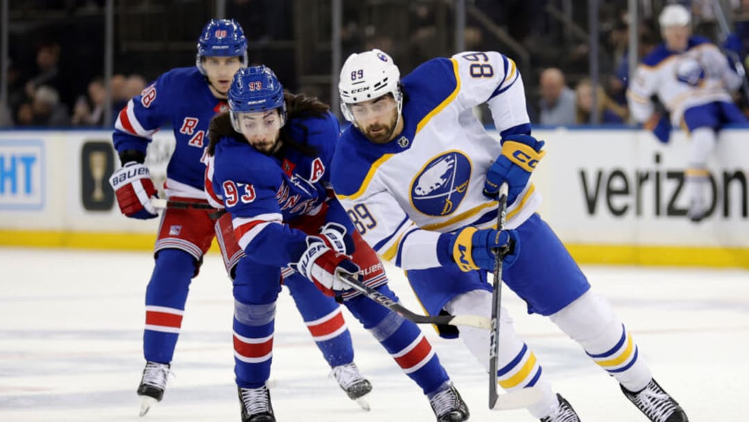 Apr 10, 2023; New York, New York, USA; New York Rangers center Mika Zibanejad (93) and Buffalo Sabres right wing Alex Tuch (89) fight for the puck during the first period at Madison Square Garden. Mandatory Credit: Brad Penner-USA TODAY Sports