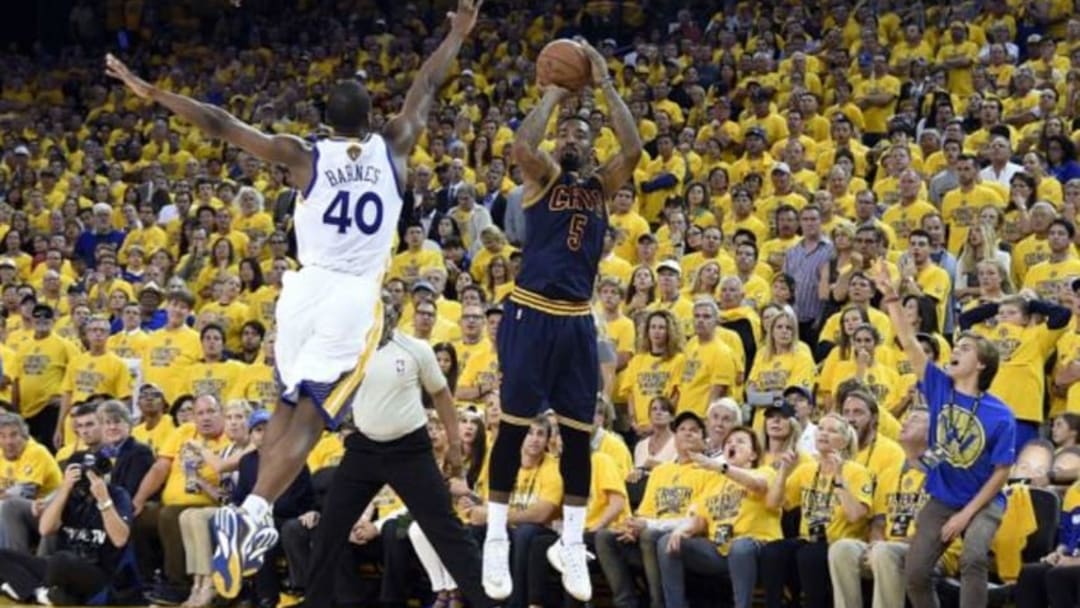 Jun 7, 2015; Oakland, CA, USA; Cleveland Cavaliers guard J.R. Smith (5) shoots the ball over Golden State Warriors forward Harrison Barnes (40) during overtime in game two of the NBA Finals at Oracle Arena. Mandatory Credit: Kyle Terada-USA TODAY Sports