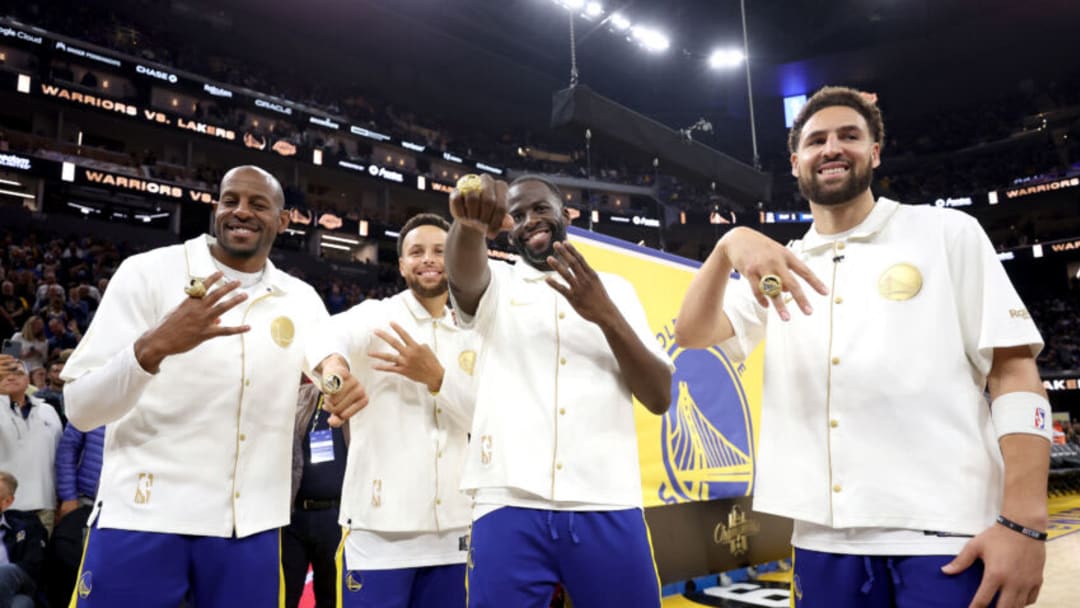SAN FRANCISCO, CALIFORNIA - OCTOBER 18: Andre Iguodala #9, Stephen Curry #30, Draymond Green #23, and Klay Thompson #11 of the Golden State Warriors pose with their championship rings in front of a championship banner during a ceremony prior to the game against the Los Angeles Lakers at Chase Center on October 18, 2022 in San Francisco, California. NOTE TO USER: User expressly acknowledges and agrees that, by downloading and or using this photograph, User is consenting to the terms and conditions of the Getty Images License Agreement. (Photo by Ezra Shaw/Getty Images)