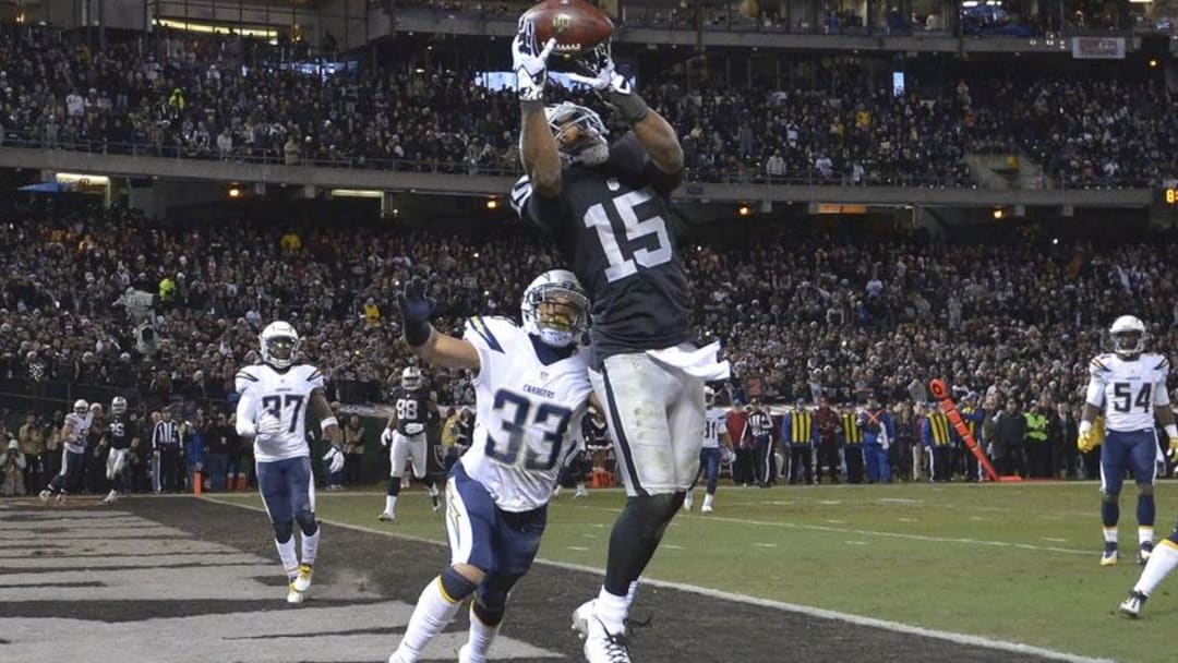 Dec 24, 2015; Oakland, CA, USA; Oakland Raiders wide receiver Michael Crabtree (15) is defended by San Diego Chargers defensive back Greg Ducre (33) during an NFL football game at O.co Coliseum. The Raiders defeated the Chargers 23-20 in overtime. Mandatory Credit: Kirby Lee-USA TODAY Sports
