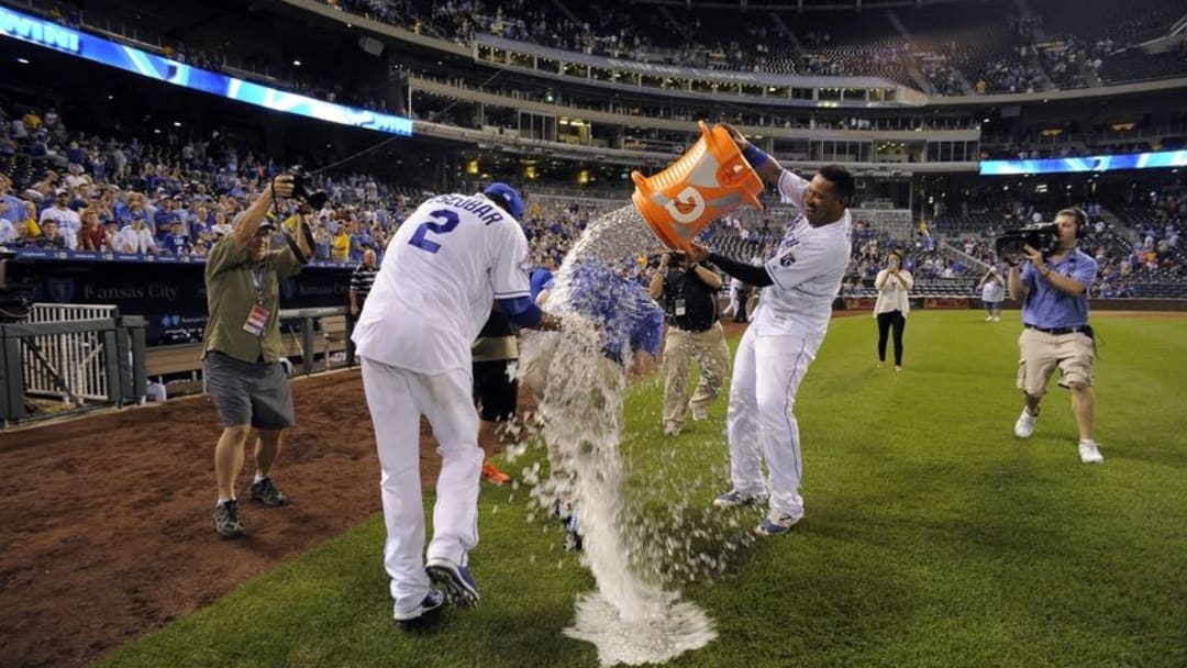 Aug 29, 2016; Kansas City, MO, USA; Kansas City Royals catcher Salvador Perez (13) dumps the water cooler on shortstop Alcides Escobar (2) and TV broadcaster Joel Goldberg after the game against the New York Yankees at Kauffman Stadium. Kansas City won 8-5. Mandatory Credit: John Rieger-USA TODAY Sports