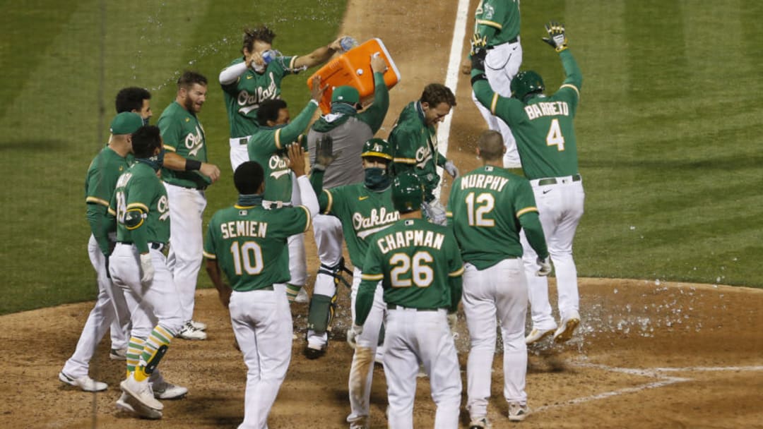 OAKLAND, CALIFORNIA - AUGUST 04: Stephen Piscotty #25 of the Oakland Athletics celebrates with his teammates at home plate after hitting a walk-off grand slam to win the game against the Texas Rangers at Oakland-Alameda County Coliseum on August 04, 2020 in Oakland, California. (Photo by Lachlan Cunningham/Getty Images)