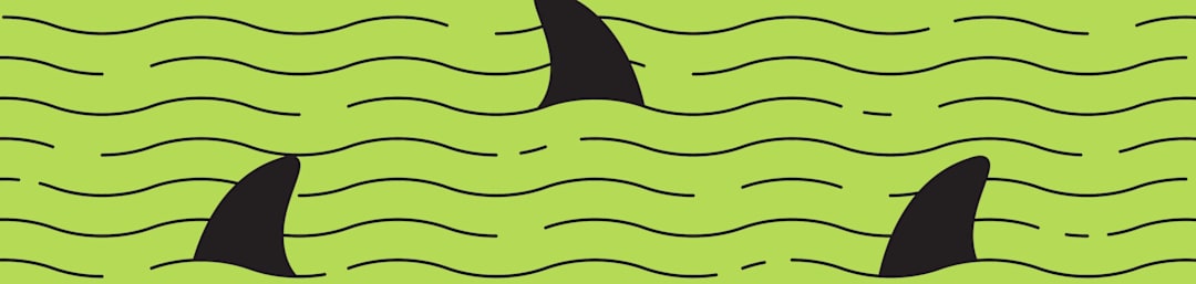 shark fins on green background
