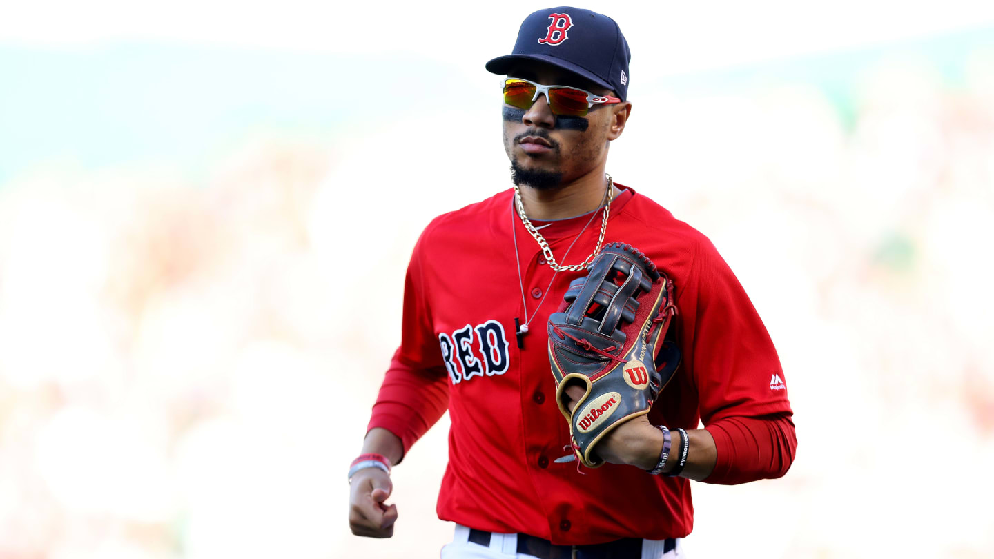 Boston Red Sox Mookie Betts holds up the Commissioner's Trophy as