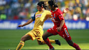 America's Lucas Castroman (L) vies for t