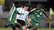 Argentina's Lionel Messi (C) vies with N