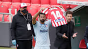 Diego Costa holds Virginia Torrecilla's number 14 shirt aloft
