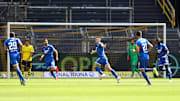 Hoffenheim celebrate their goal amid disappointed Borussia Dortmund players.