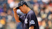 New York Yankees pitcher Masahiro Tanaka tips his hat against the Boston Red Sox