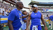 Eric Dickerson speaking with Aaron Donald on the Rams' sideline