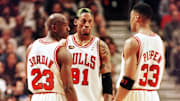 Dennis Rodman of the Chicago Bulls (C) talks to te
