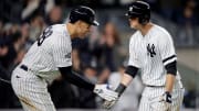 Aaron Judge and DJ LeMahieu high-five at home plate during the 2019 ALDS against the Twins.
