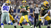 Packers quarterback Aaron Rodgers hesitates in the pocket as the pass-rush crashes in during a game against the Cowboys.