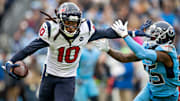Texans wideout De'Andre Hopkins stiff-arming a Titans defender 