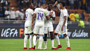 Real Madrid celebrate after claiming victory at the San Siro