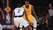 LeBron James guards Kawhi Leonard.