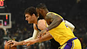 LeBron James covering the Bucks' Brook Lopez in the Lakers' loss on Thursday.