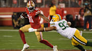 Raheem Mostert shrugging off Green Bay's defense as he tore through them all night.