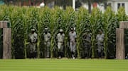 Yankees and White Sox emerge from the field of corn onto the Field of Dreams.