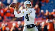 Raiders quarterback Derek Carr gets set for a pass downfield against the Broncos.