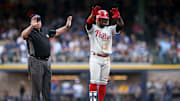 Herrera salutes to the Phillie bench after a double against the Brewers