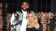 Khloe Kardashian and Tristan Thompson cuddle up at friend's birthday party.