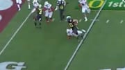 Oregon Ducks QB Justin Herbert stiff arms Wisconsin Badgers defender on TD run