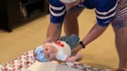Buffalo Bills fan inducts infant into fan base by "putting it through table."