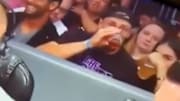 George Kittle chugs beer while sitting behind broadcast table of WWE Smackdown on Tuesday.
