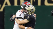 Drew Brees hugs Tom Brady. 