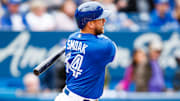 Justin Smoak swinging at a pitch in a game against the Tampa Bay Rays