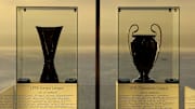 The UEFA Europa League trophy (L) and th