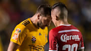 Andre-Pierre Gignac y Rodrigo Salinas se encaran en un partido.