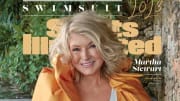 Martha Stewart poses in a white one-piece and an orange cape.