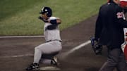 1998 New York Yankees infielder Homer Bush sliding home.