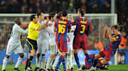 Barcelona's captain Carles Puyol (R) rea
