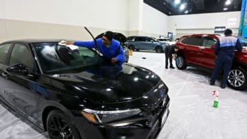 Rickey Roach cleans up a 2023 Honda Civic SI at the 2023 Milwaukee Auto Show at the Wisconsin Center on Thursday, Feb. 23, 2023 at 400 W. Wisconsin Ave.MJS-carshow__p2