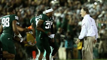 PASADENA, CA - JANUARY 01: Michigan State Spartans head coach Mark Dantonio is missed as defensive end Shilique Calhoun #89 and cornerback Darqueze Dennard #31 pour the Gatorade on the field after defeating the Stanford Cardinal 24-20 during the 100th Rose Bowl Game presented by Vizio at the Rose Bowl on January 1, 2014 in Pasadena, California. (Photo by Stephen Dunn/Getty Images)