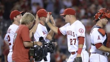Aug 7, 2015; Anaheim, CA, USA; Los Angeles Angels center fielder Mike Trout (27) celebrates after defeating the Baltimore Orioles 8-4 at Angel Stadium of Anaheim. Mandatory Credit: Richard Mackson-USA TODAY Sports