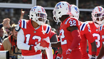 Oct 9, 2022; Foxborough, Massachusetts, USA; New England Patriots cornerback Jack Jones (13) is congratulated by safety Devin McCourty (32) after an interception during the first half against the Detroit Lions at Gillette Stadium. Mandatory Credit: Bob DeChiara-USA TODAY Sports