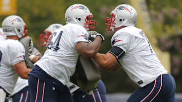 Aug 4, 2014; Richmond, VA, USA; New England Patriots guard Logan Mankins (70) and Patriots guard Chris Barker (64) participate in drills during joint practice with the Washington Redskins on day ten of training camp at the Bon Secours Washington Redskins Training Center. Mandatory Credit: Geoff Burke-USA TODAY Sports