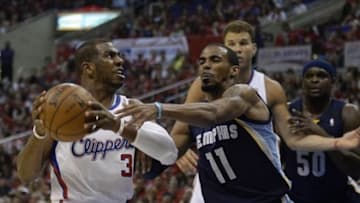 Apr 20, 2013; Los Angeles, CA, USA; Memphis Grizzlies point guard Mike Conley (11) defends against Los Angeles Clippers point guard Chris Paul (3) during game one of the first round of the 2013 NBA Playoffs at the Staples Center. Mandatory Credit: Richard Mackson-USA TODAY Sports