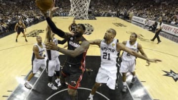 Jun 16, 2013; San Antonio, TX, USA; Miami Heat small forward LeBron James (6) lays the ball up past San Antonio Spurs power forward Tim Duncan (21) during the second quarter of game five in the 2013 NBA Finals at the AT&T Center. Mandatory Credit: Brendan Maloney-USA TODAY Sports
