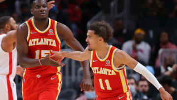 ATLANTA, GEORGIA - DECEMBER 13: Clint Capela #15 of the Atlanta Hawks reacts after dunking alley-oop pass from Trae Young #11 against the Houston Rockets during the first half at State Farm Arena on December 13, 2021 in Atlanta, Georgia. NOTE TO USER: User expressly acknowledges and agrees that, by downloading and or using this photograph, User is consenting to the terms and conditions of the Getty Images License Agreement. (Photo by Kevin C. Cox/Getty Images)