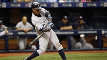 May 29, 2016; St. Petersburg, FL, USA; New York Yankees second baseman Starlin Castro (14) hits a two-run home run during the seventh inning against the Tampa Bay Rays at Tropicana Field. Mandatory Credit: Kim Klement-USA TODAY Sports